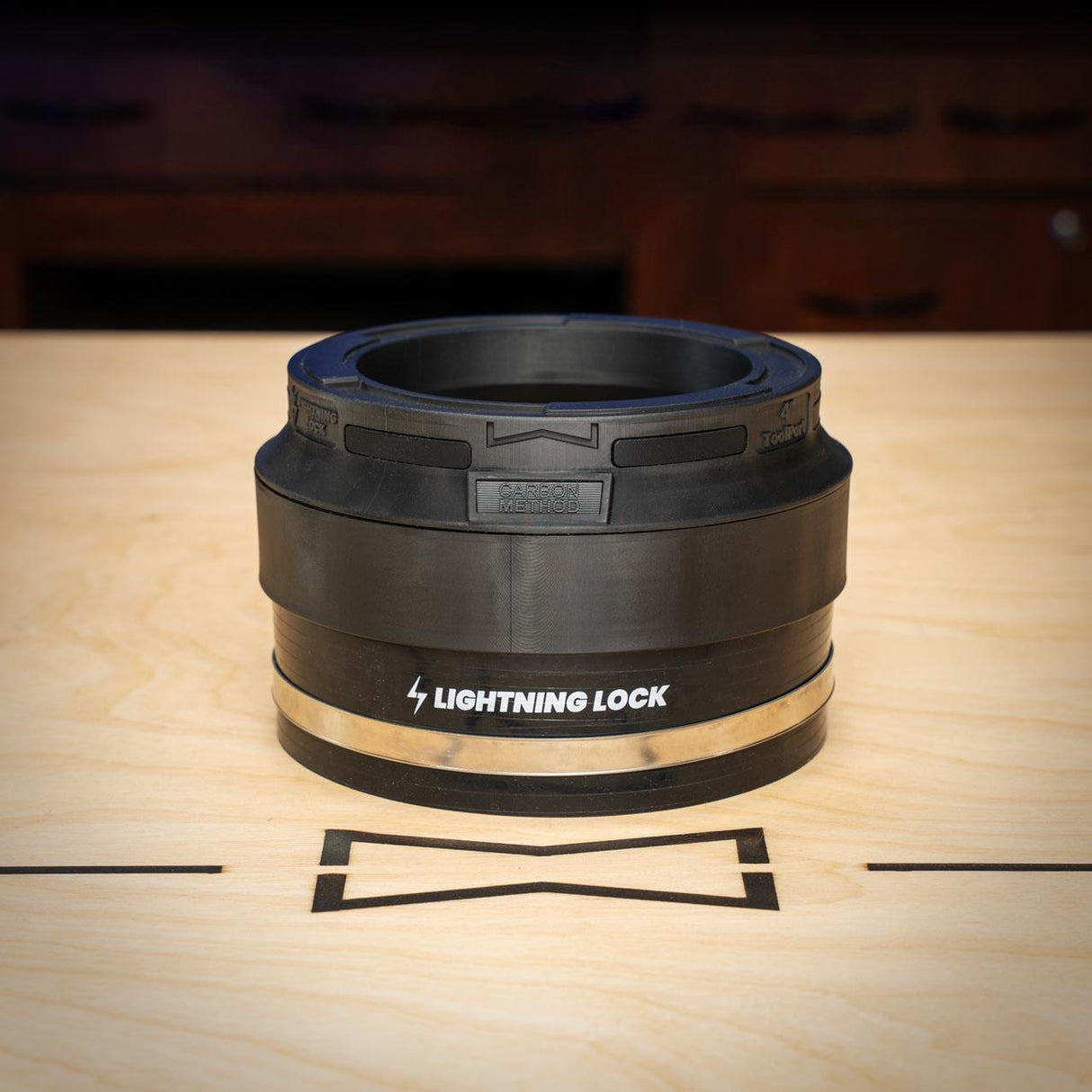 Black rubber gasket with 'Lightning Lock' branding on a wooden surface