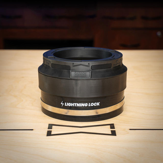 Black rubber gasket with 'Lightning Lock' branding on a wooden surface