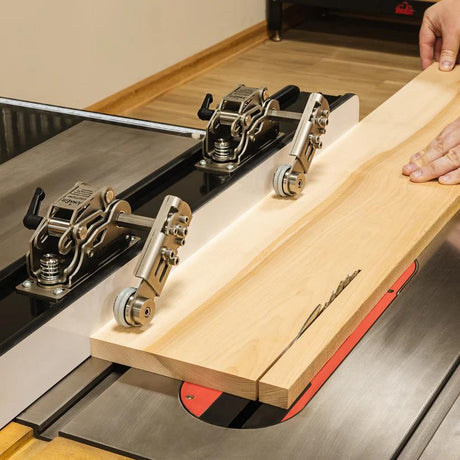JessEm Clear-Cut STS Stock Guides holding wooden board against fence during table saw cut for safer operation.